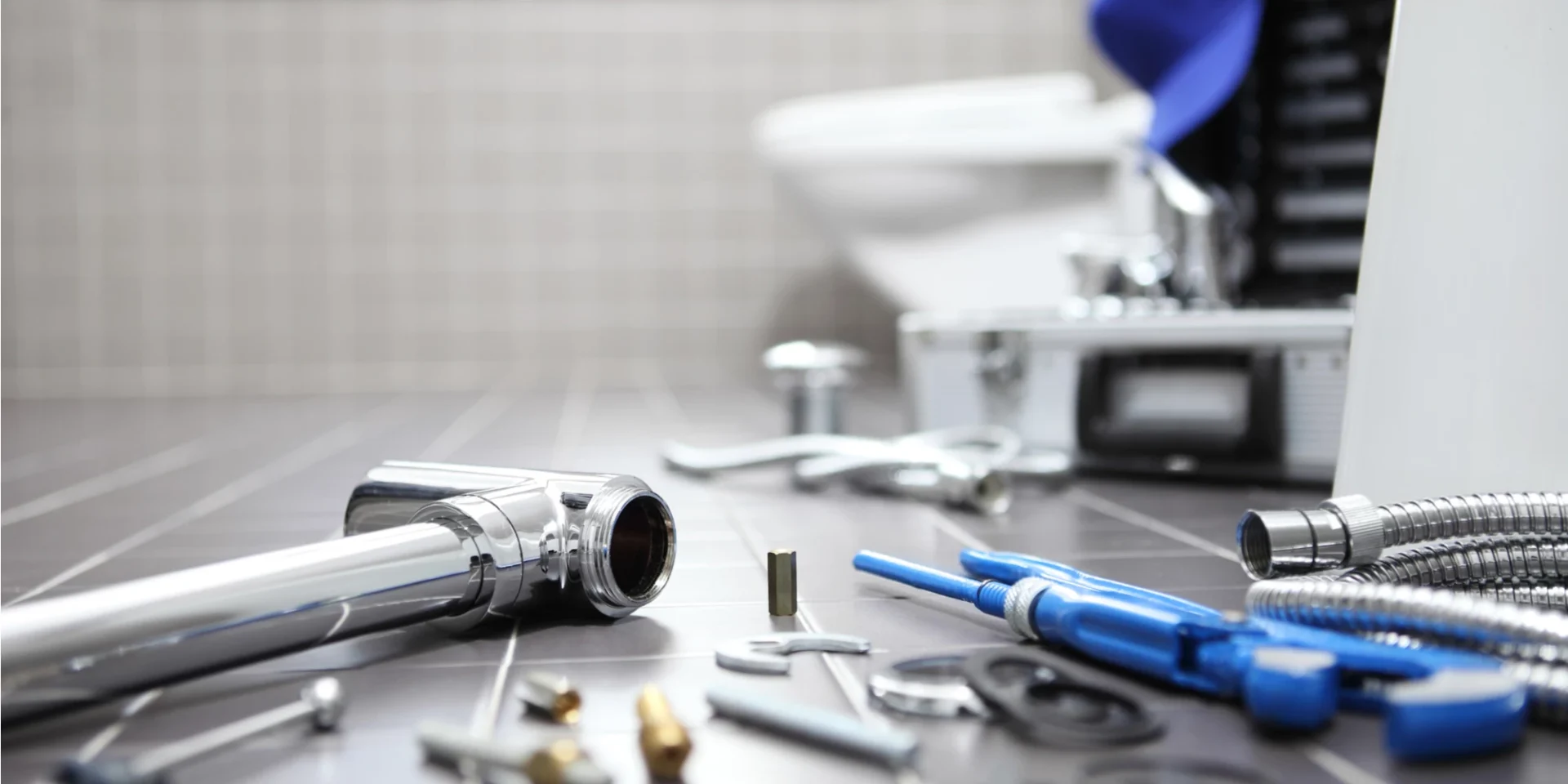 a bathroom counter with various tools and equipment scattered around